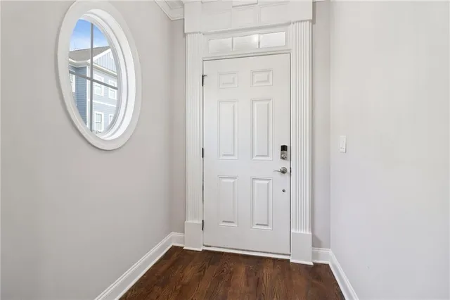 a view of a livingroom with wooden floor and a fireplace