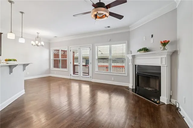 a view of empty room with wooden floor and fireplace