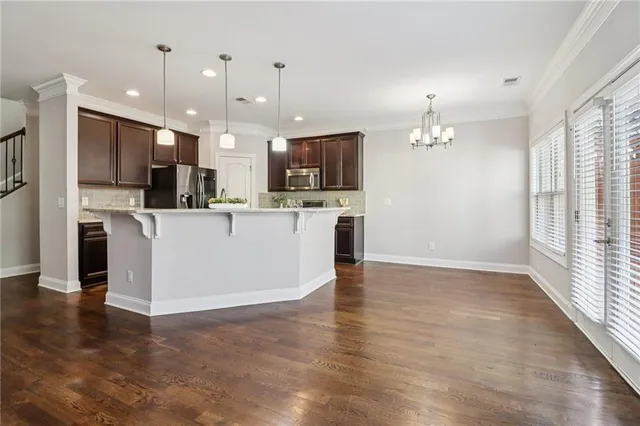 a kitchen with stainless steel appliances a sink stove and refrigerator