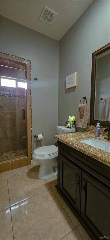 1305 Mountain Road Mission, TX 78573 - Photo 28 of 43 a bathroom with a granite countertop sink a toilet and shower