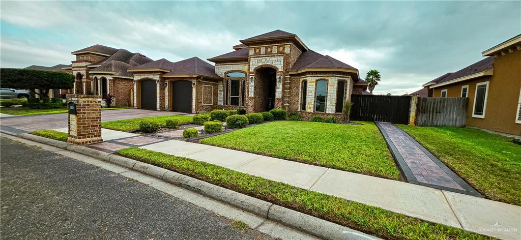 1305 Mountain Road Mission, TX 78573 - Photo 3 of 43 a front view of a house with a yard