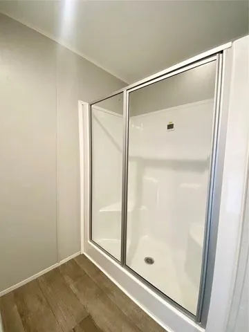 a bathroom with a glass shower door