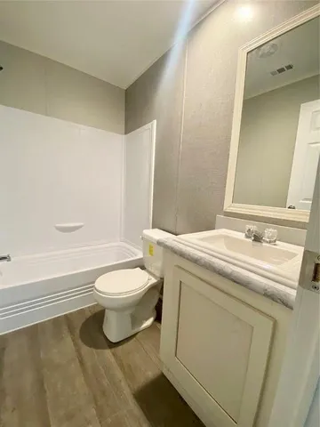 a bathroom with a toilet a sink and a bathtub