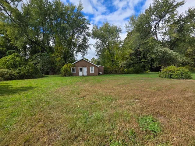 a view of a house with a yard and garage