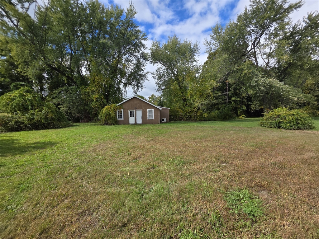 1415 Park Street Palmer, MA 01069 - Photo 11 of 12 a view of a house with a yard and garage