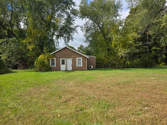 a house with green field in front of it