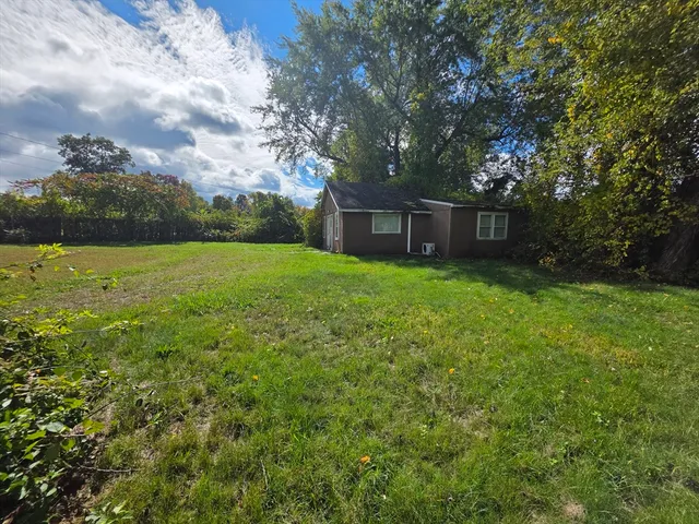 a view of a backyard with large trees