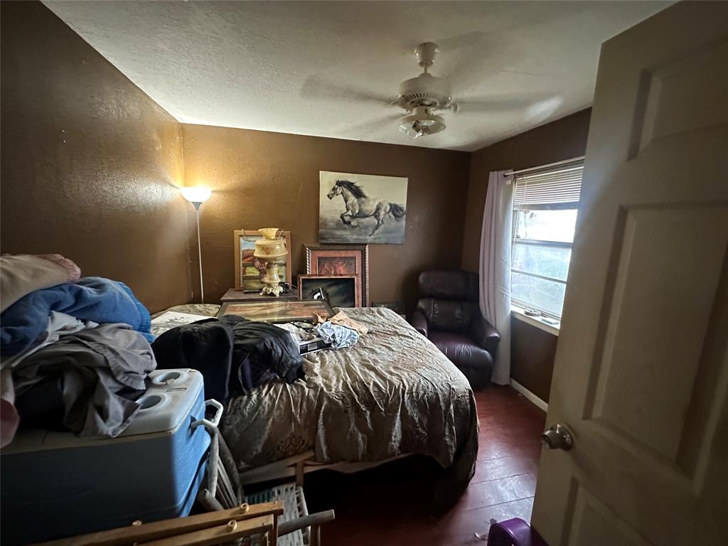 654 Rutgers Drive Lancaster, TX 75134 - Photo 13 of 18 a bedroom with a bed and window
