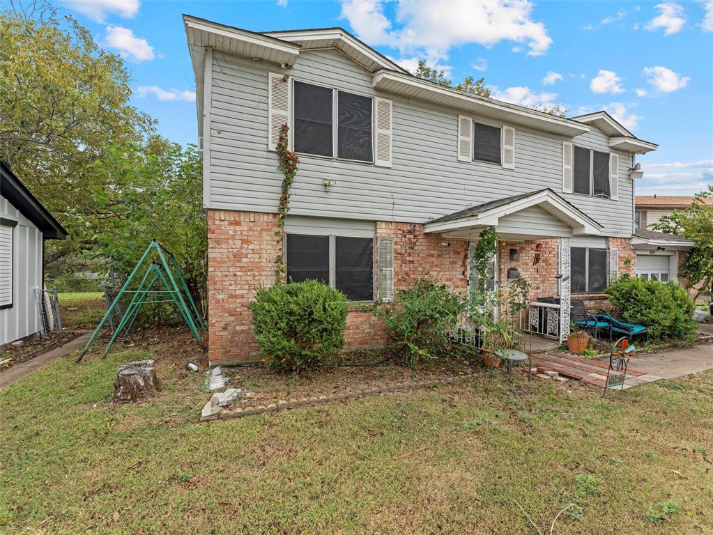 654 Rutgers Drive Lancaster, TX 75134 - Photo 2 of 18 a front view of a house with garden