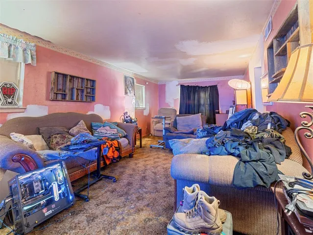 a living room with furniture and a floor to ceiling window