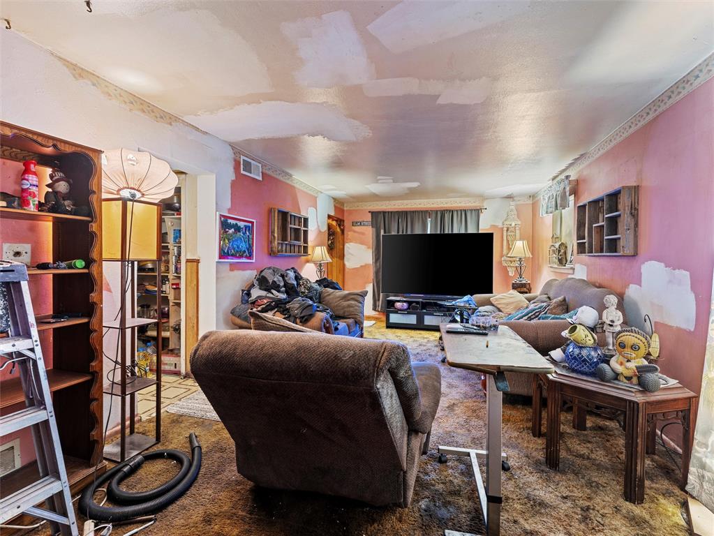 654 Rutgers Drive Lancaster, TX 75134 - Photo 6 of 18 a living room with furniture a flat screen tv and a table