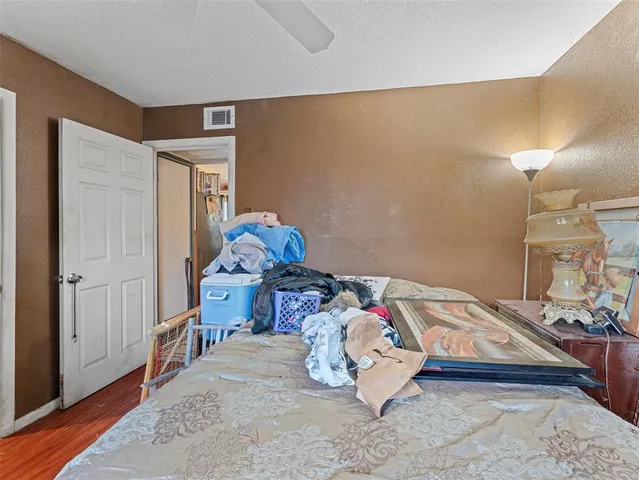 a bedroom with a bed and a dresser in it