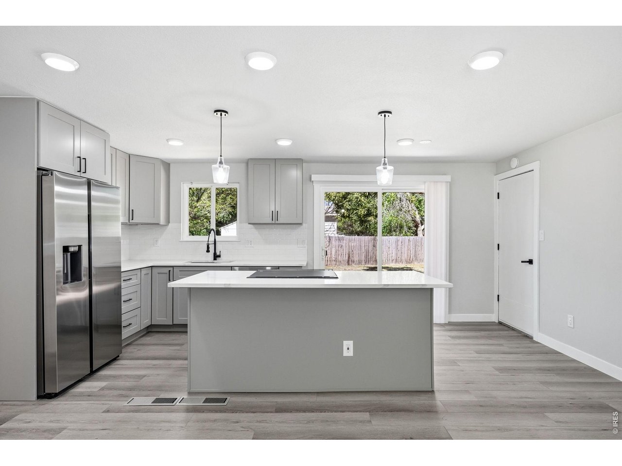 1035 6th Street Berthoud, CO 80513 - Photo 12 of 37 a kitchen with kitchen island a sink stainless steel appliances and cabinets