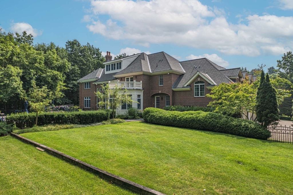 9 Regency Ridge Andover, MA 01810 - Photo 3 of 5 a view of a big house with a big yard and potted plants in front of the house