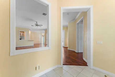 a large white kitchen with granite countertop a sink and dishwasher with wooden floor