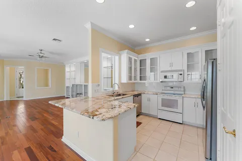 a kitchen with stainless steel appliances granite countertop a sink and cabinets