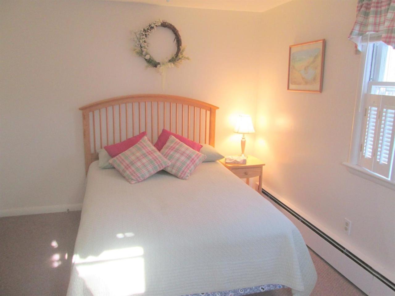 71 Seabrook Road Hyannis, MA 02601 - Photo 11 of 13 a bedroom with a bed and a window