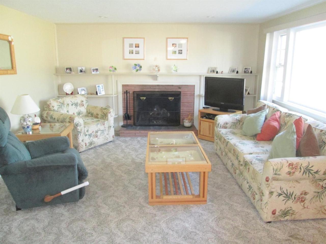 71 Seabrook Road Hyannis, MA 02601 - Photo 3 of 13 a living room with furniture and a fireplace
