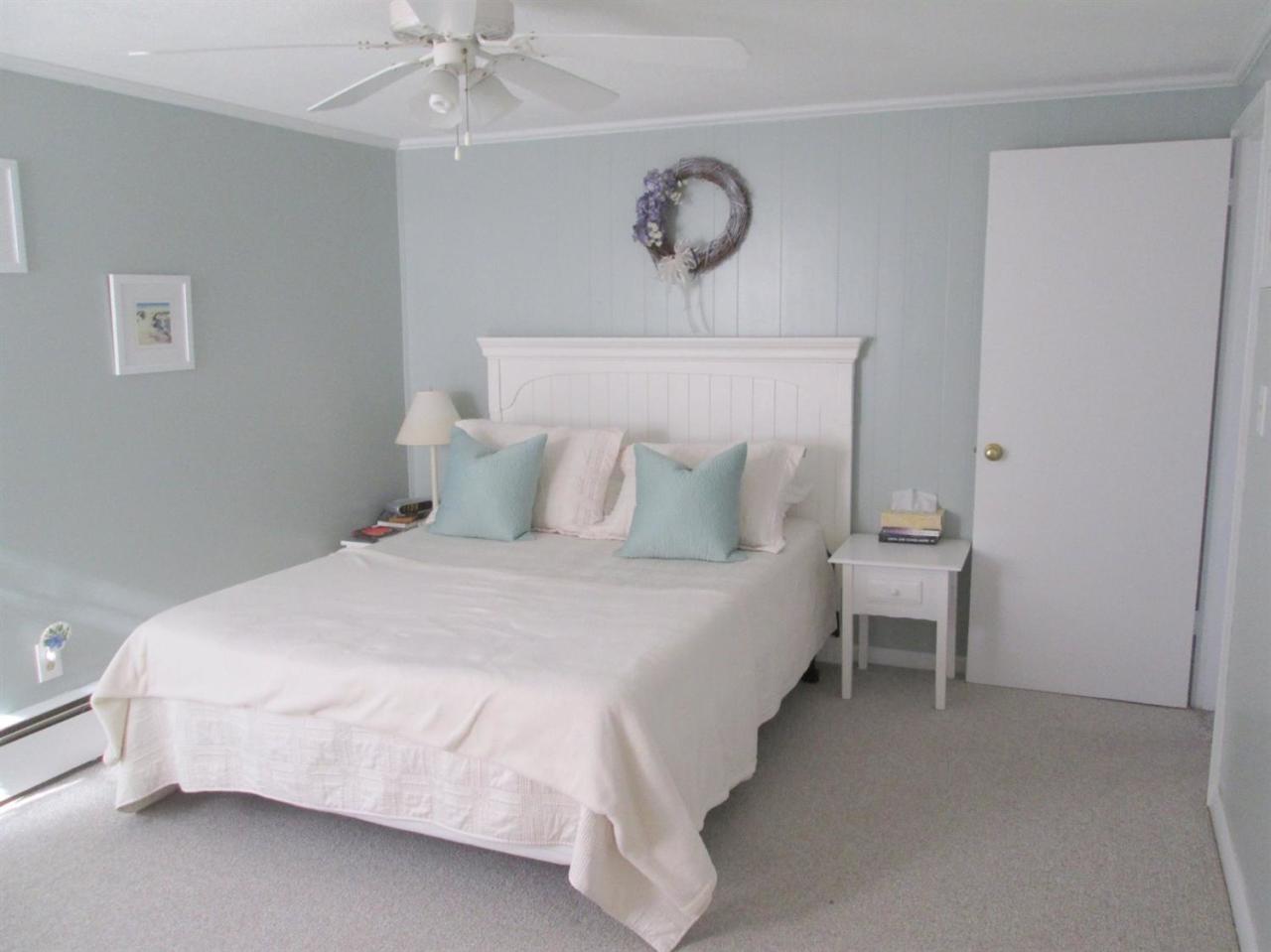 71 Seabrook Road Hyannis, MA 02601 - Photo 7 of 13 a bedroom with a bed and a chandelier