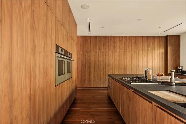 a kitchen with stainless steel appliances a sink and cabinets