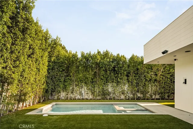 a view of a patio with table and chairs with wooden fence and plants