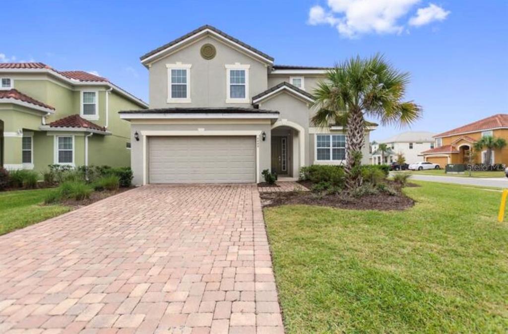 4449 Shiva Loop Kissimmee, FL 34746 - Photo 1 of 1 a front view of a house with garden