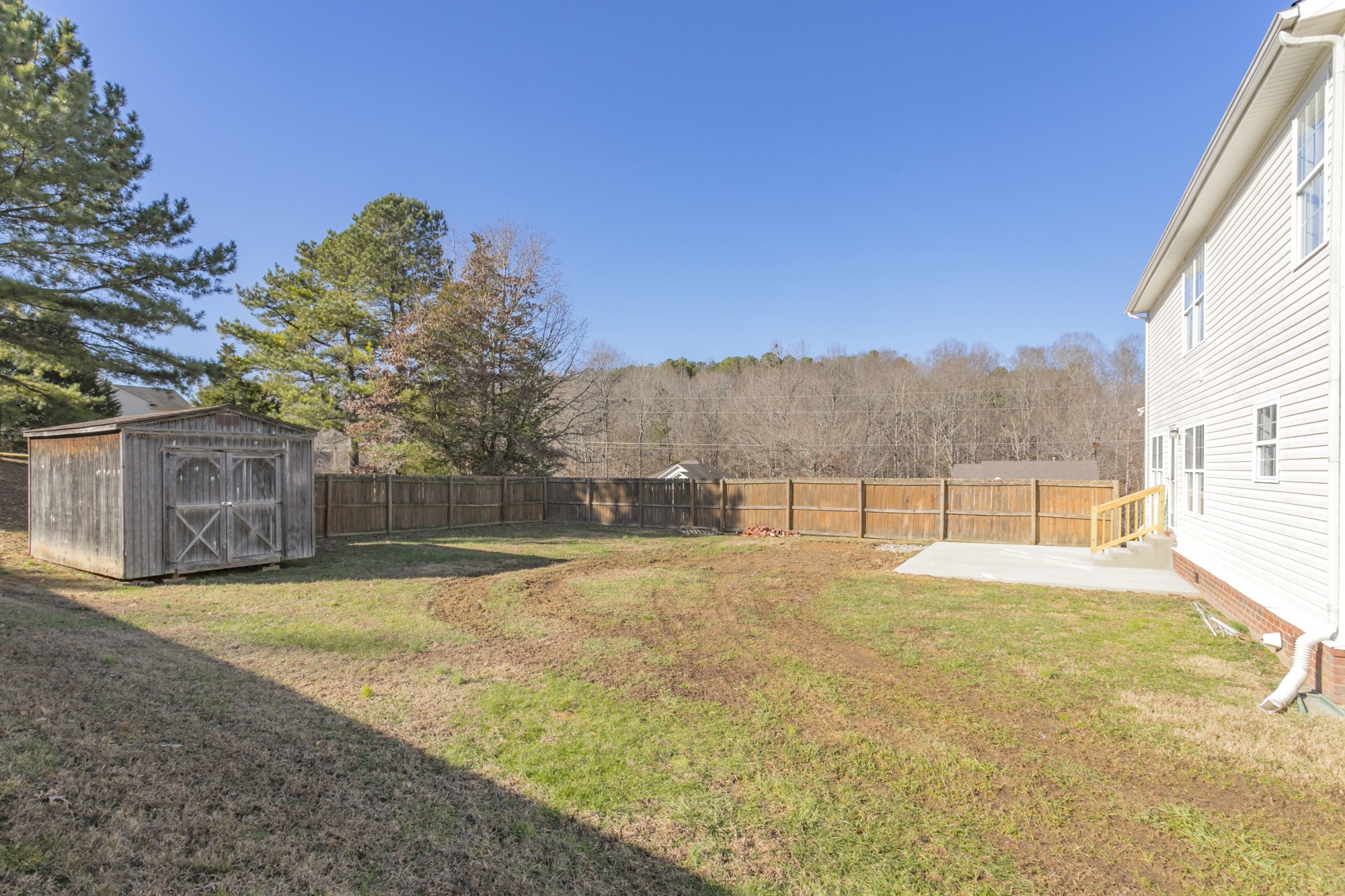 7596 Cherokee Hills Road Fairview, TN 37062 - Photo 29 of 31 a view of backyard with large trees and wooden fence
