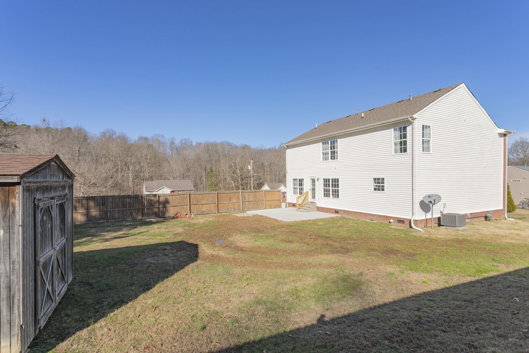 7596 Cherokee Hills Road Fairview, TN 37062 - Photo 30 of 31 a view of a house with backyard and trees in the background