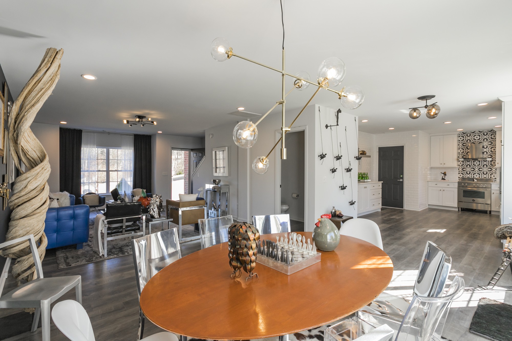 7596 Cherokee Hills Road Fairview, TN 37062 - Photo 5 of 31 a dining room with wooden floor a glass table and chairs