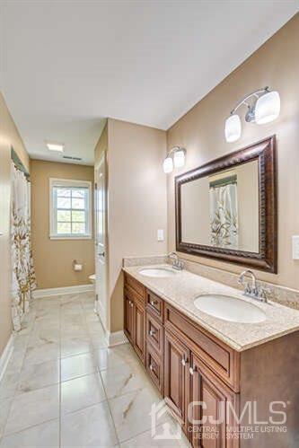 18 Ramsey Road Edison, NJ 08820 - Photo 50 of 54 a spacious bathroom with a granite countertop sink a mirror and a bathtub
