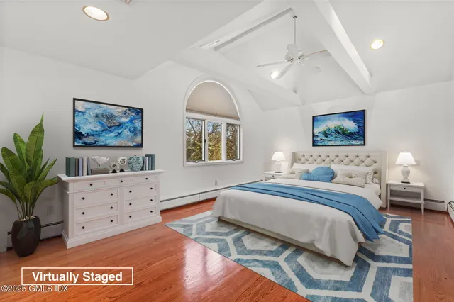 a spacious bedroom with a large bed and a chandelier