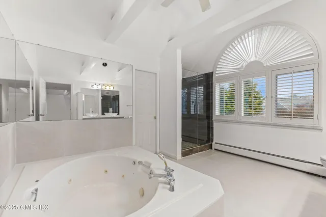 a bathroom with a bathtub and a shower