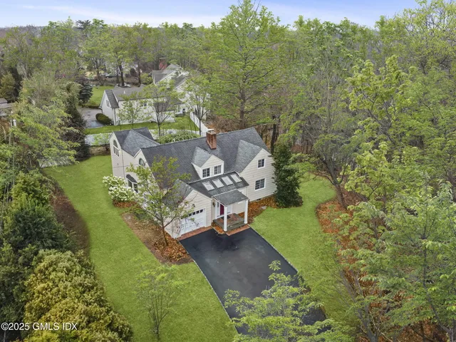 an aerial view of a house with a yard