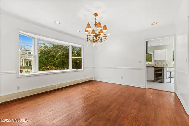 a view of a room with wooden floor and a window