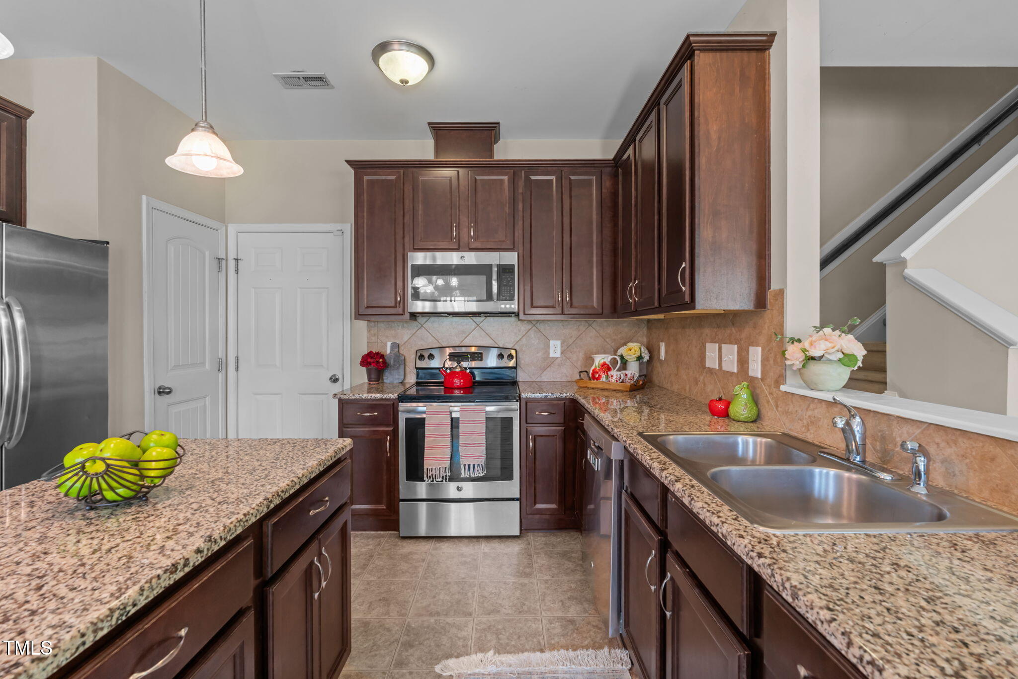 60 Taplow Trail Cameron, NC 28326 - Photo 9 of 50 a kitchen with stainless steel appliances granite countertop a sink a stove and a wooden cabinets