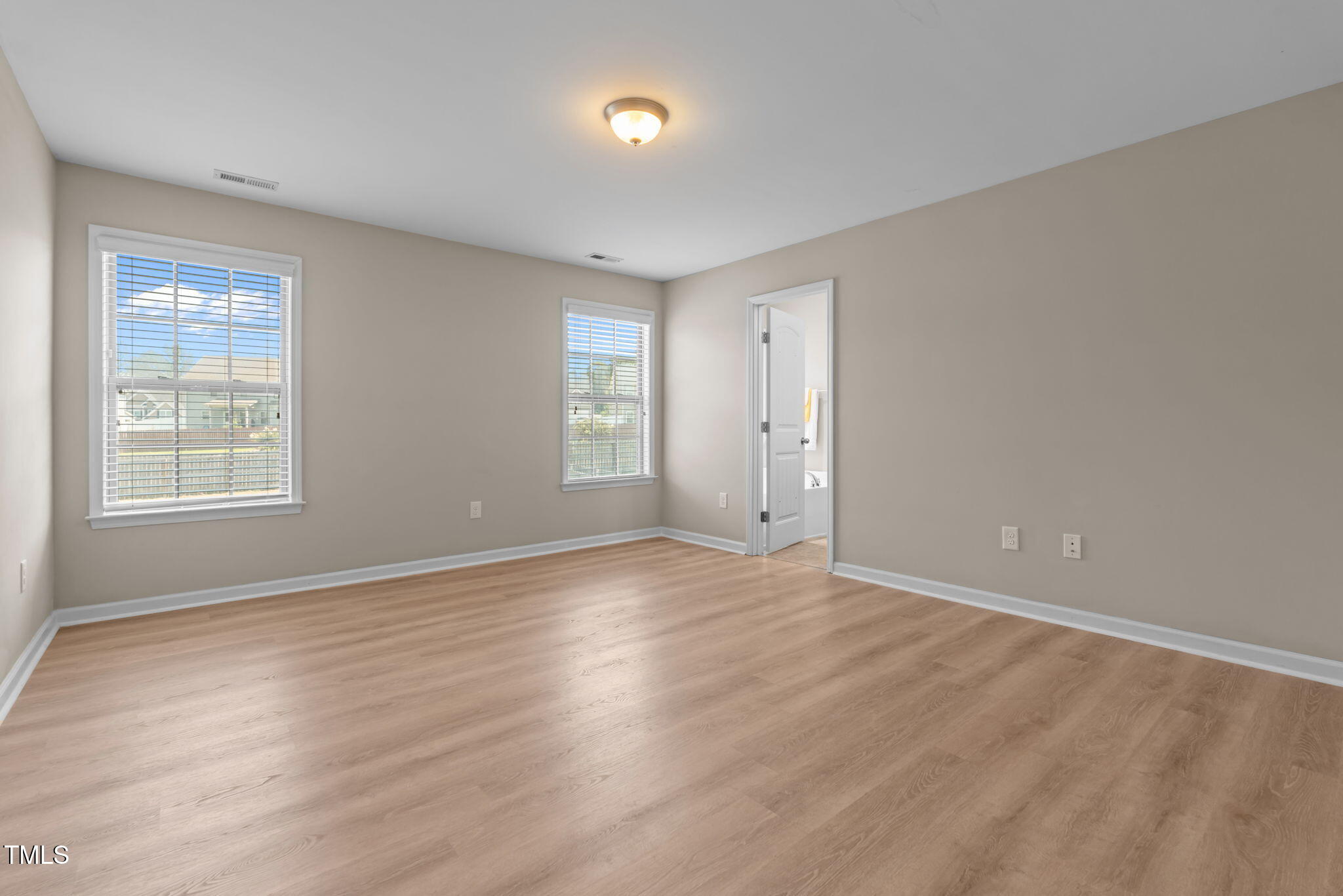 60 Taplow Trail Cameron, NC 28326 - Photo 19 of 50 a view of an empty room with wooden floor and a window