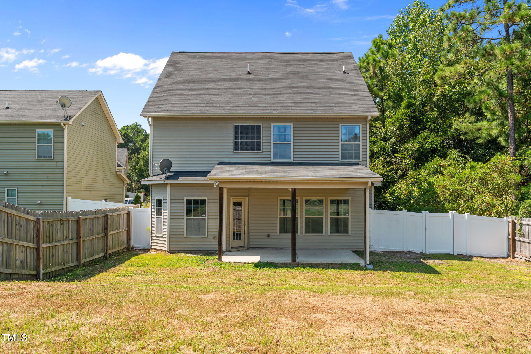 60 Taplow Trail Cameron, NC 28326 - Photo 38 of 50 a view of a house with a wooden fence and a large tree