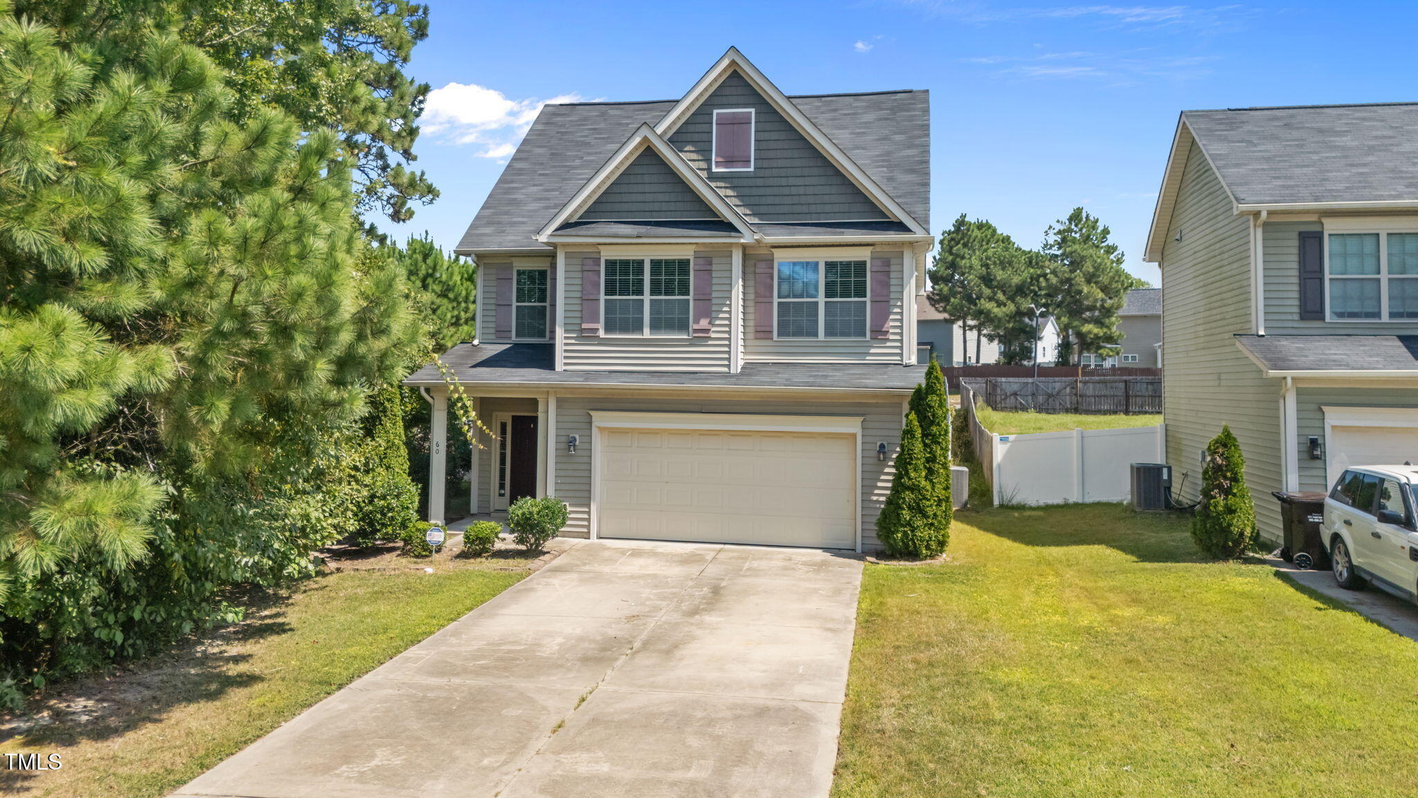 60 Taplow Trail Cameron, NC 28326 - Photo 41 of 50 a front view of a house with a yard and garage