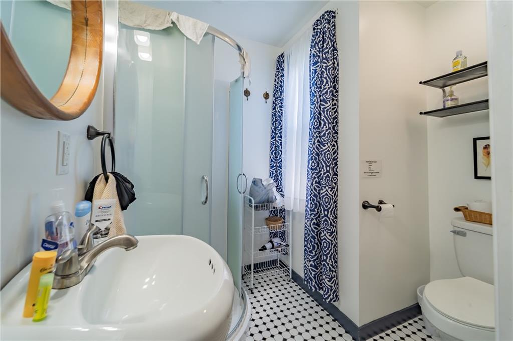 102 Secane Avenue Pittsburgh, PA 15211 - Photo 24 of 50 a bathroom with a sink a toilet and shower