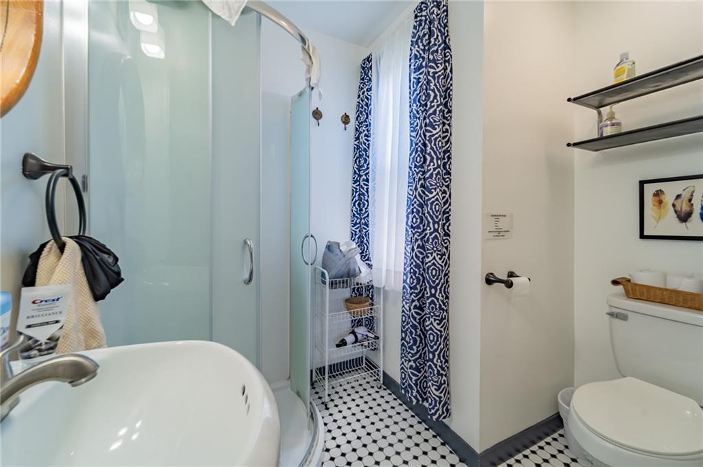 102 Secane Avenue Pittsburgh, PA 15211 - Photo 25 of 50 a bathroom with a sink a toilet and shower