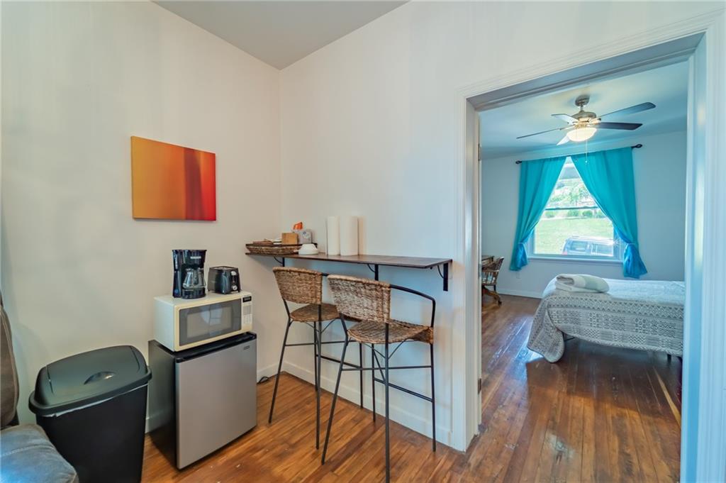 102 Secane Avenue Pittsburgh, PA 15211 - Photo 29 of 50 a workspace with furniture window and wooden floor