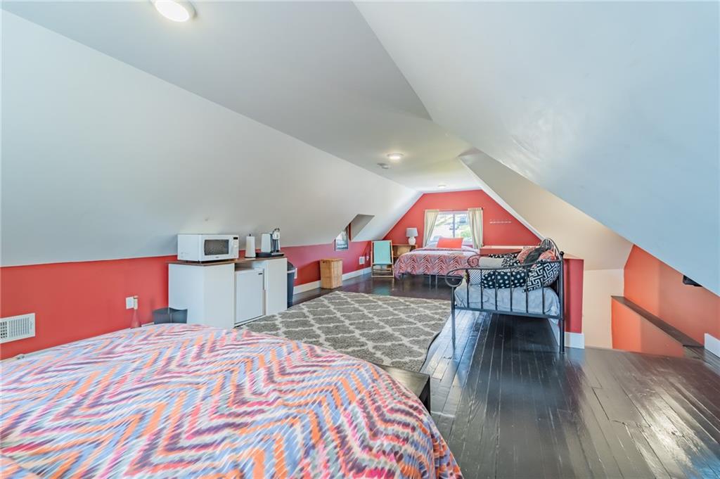 102 Secane Avenue Pittsburgh, PA 15211 - Photo 35 of 50 a bed room with a bed and a book shelf