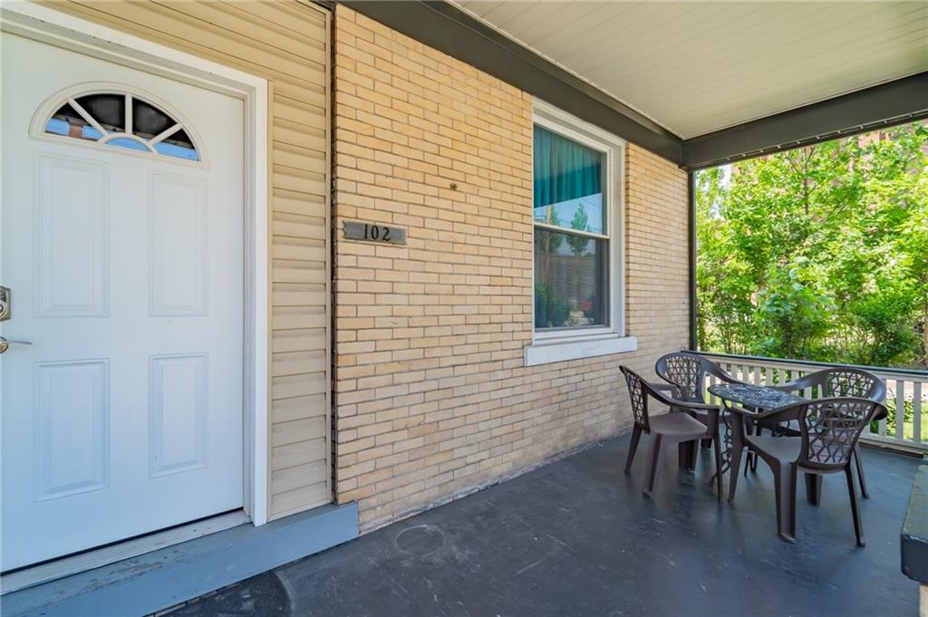 102 Secane Avenue Pittsburgh, PA 15211 - Photo 4 of 50 a view of a patio with table and chairs and couches with wooden floor
