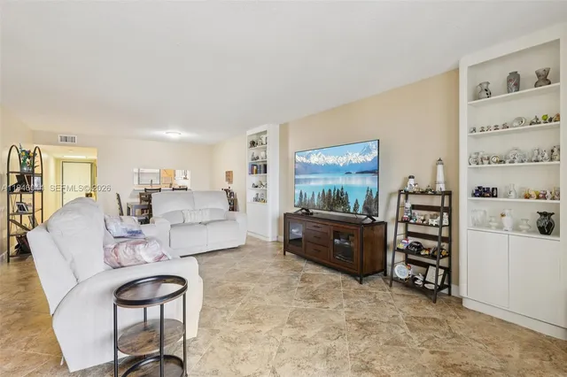 a kitchen with stainless steel appliances granite countertop a sink a stove a microwave and cabinets