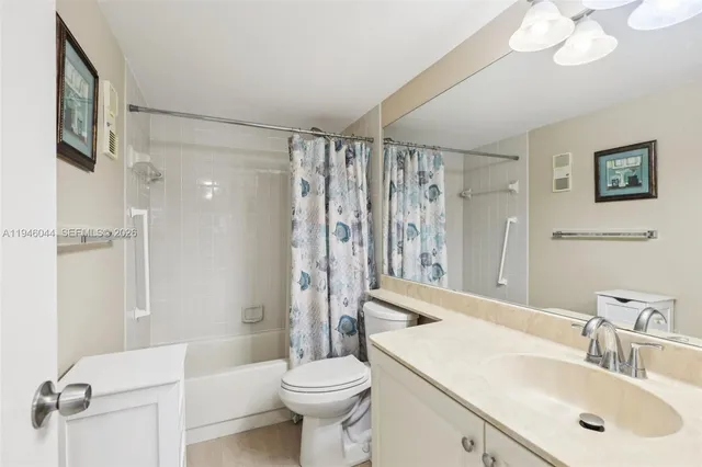 a bathroom with a shower toilet and sink