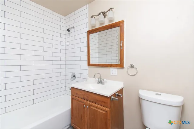a bathroom with a sink a toilet and bathtub