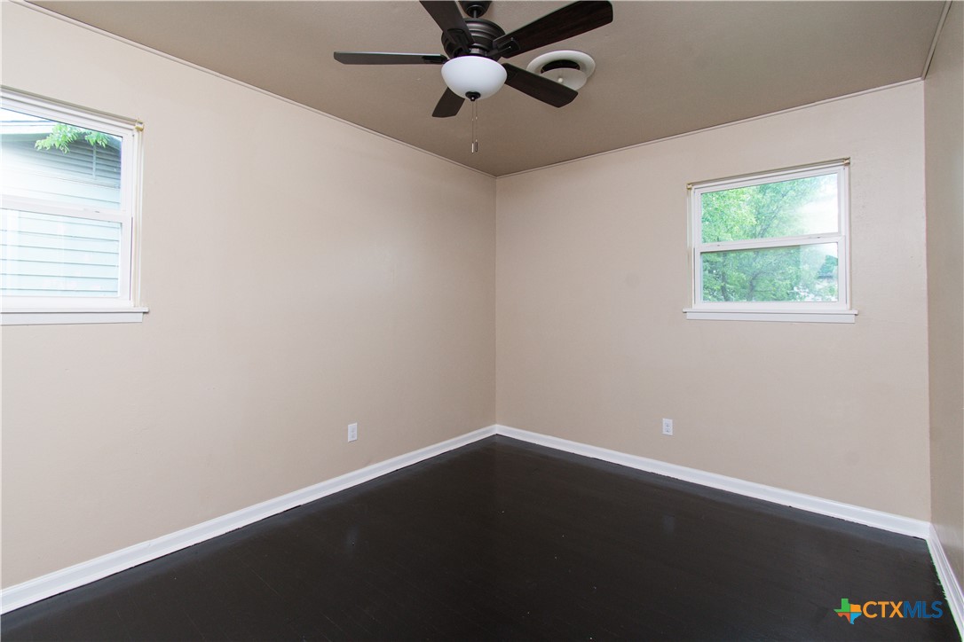 1312 Stephen Street Killeen, TX 76549 - Photo 12 of 19 an empty room with a window and a ceiling fan