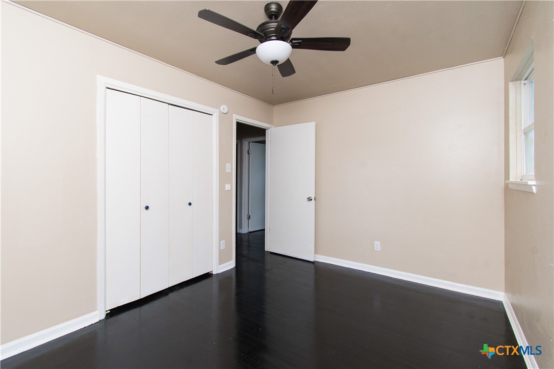 1312 Stephen Street Killeen, TX 76549 - Photo 14 of 19 an empty room with wooden floor and a ceiling fan