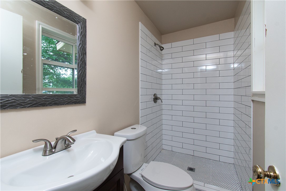 1312 Stephen Street Killeen, TX 76549 - Photo 18 of 19 a bathroom with a sink a toilet and shower