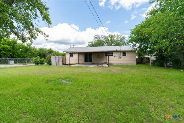 a view of a house with pool and a yard